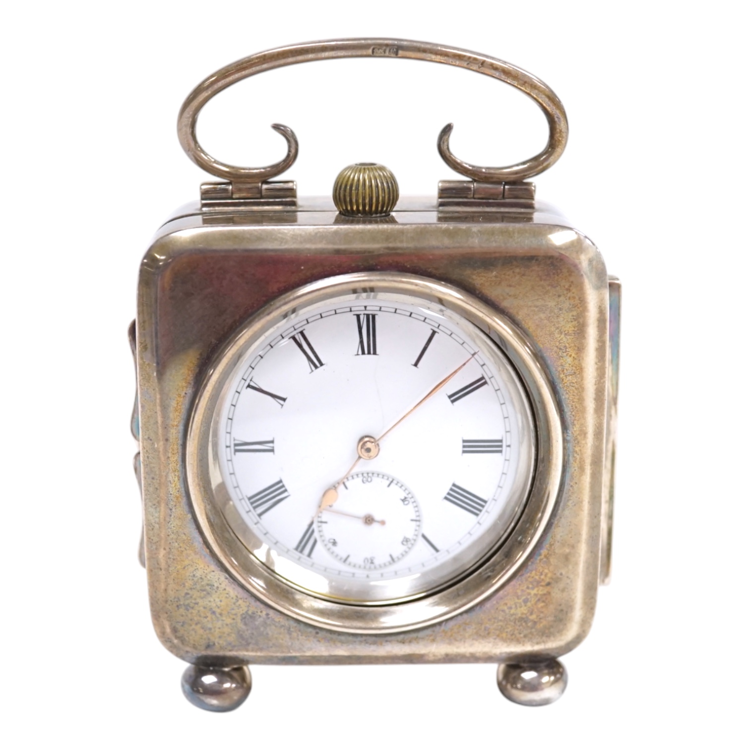 An Edwardian silver travelling pocket watch case, Birmingham, 1904, on bun feet, containing a Swiss white metal open face pocket watch. Condition - fair